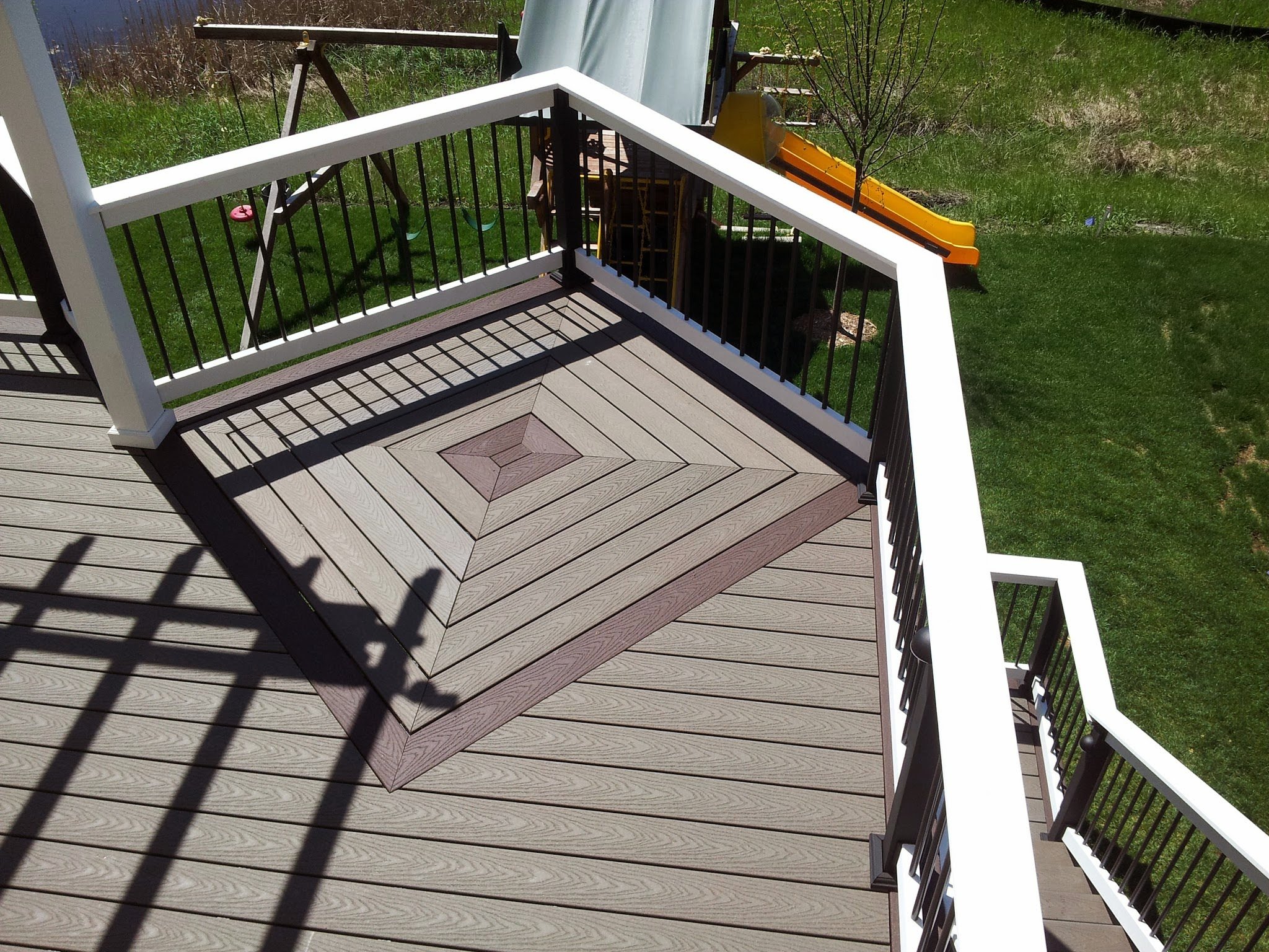 Two-tone composite deck with curved edge detailing, built in Minnesota.