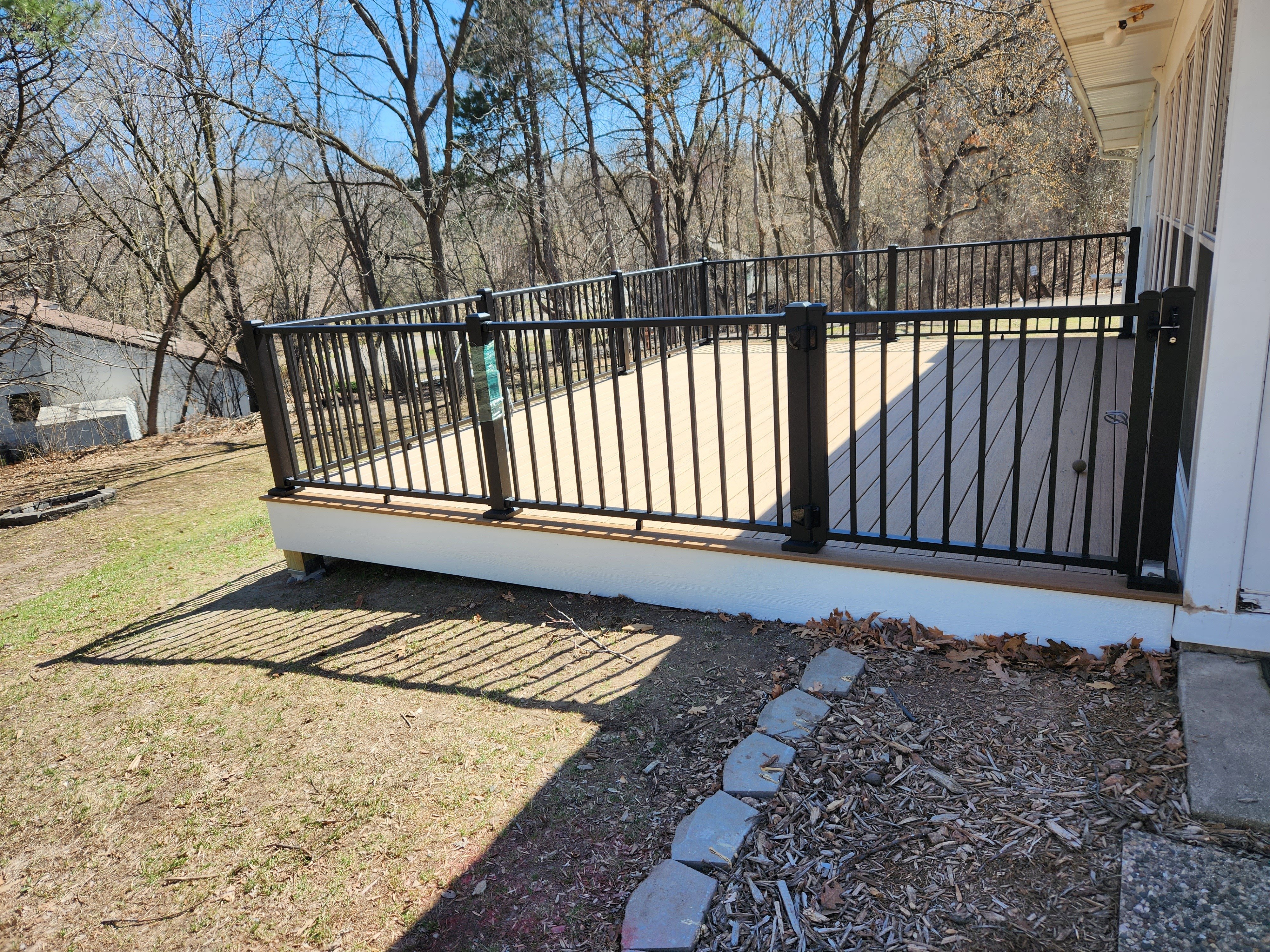 Simple back deck with natural wood finish, built by Minnesota carpenters
