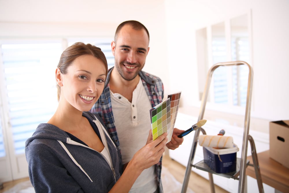Couple in new house choosing color for walls