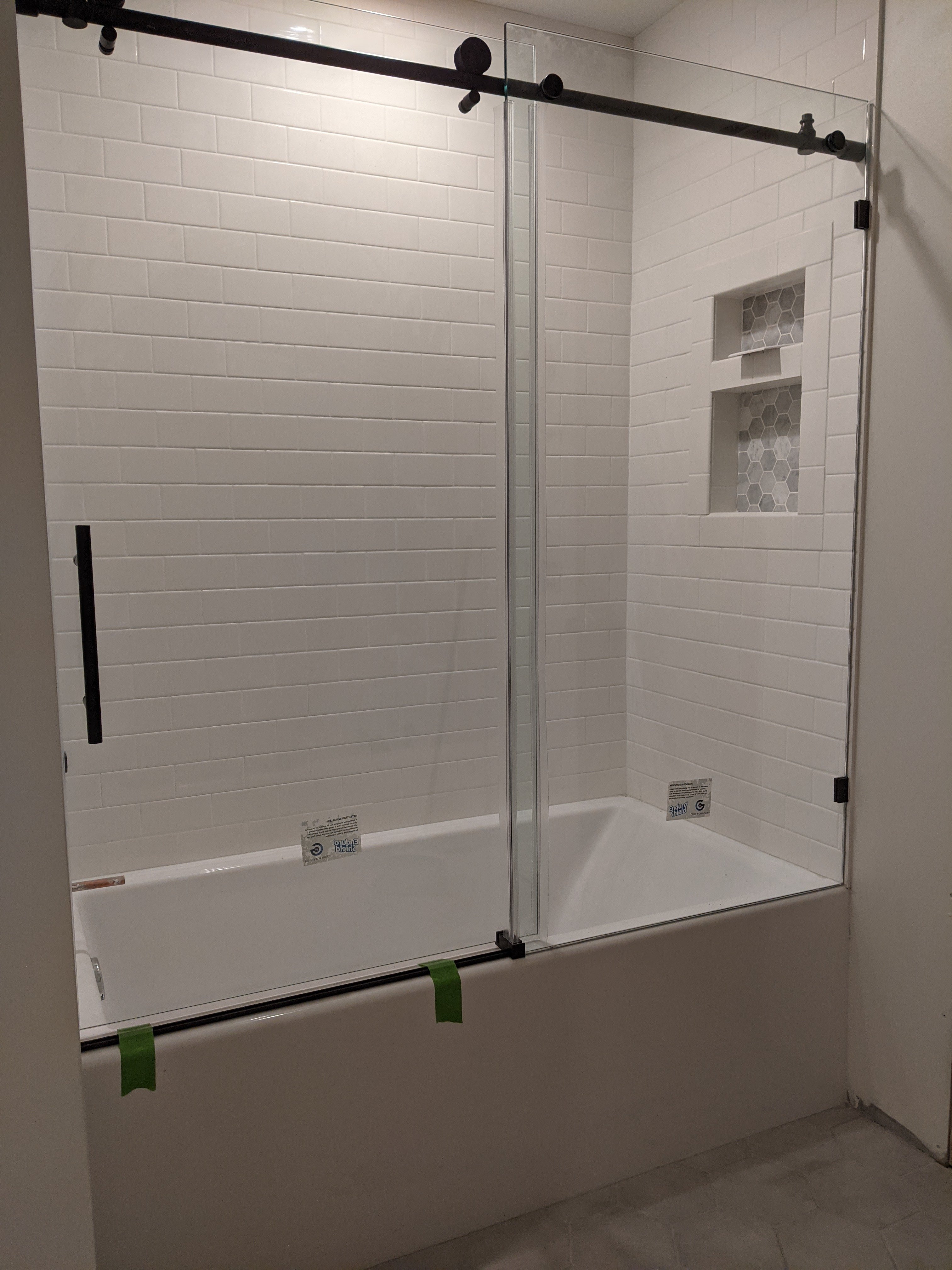 Modern shower remodel with sleek tile work, glass door, and contemporary fixtures in a stylish bathroom.